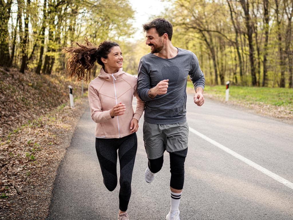 Couple running outdoors